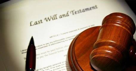 A gavel and pen rest on a document titled "Last Will and Testament.
